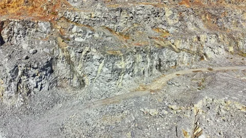 Granite quarry shows workers extracting stone at a location where large rocks Stock Footage 341700827
