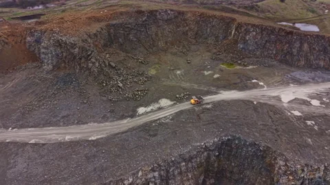 Granite quarry shows workers on site and large rock formations in background Stock Footage 331074420