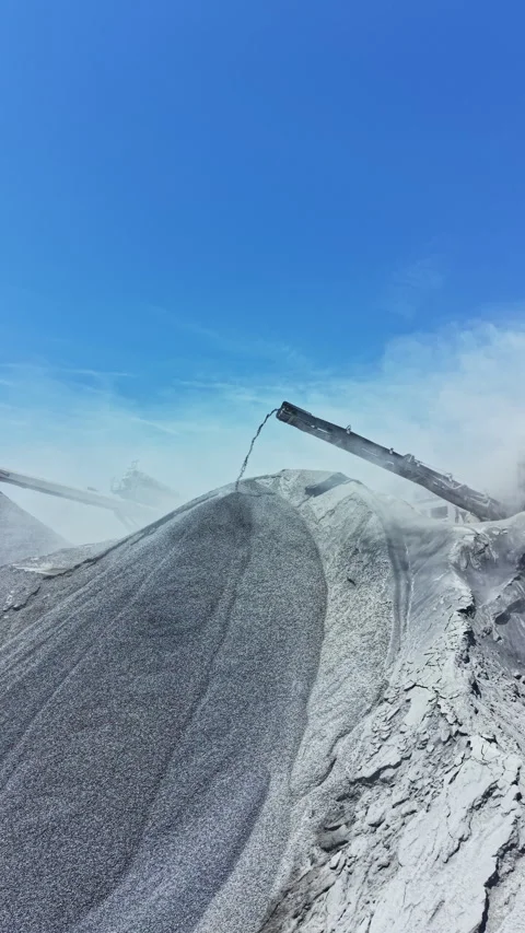 Granite quarry site with machinery processing stone in bright sunlight during Stock Footage 337909648