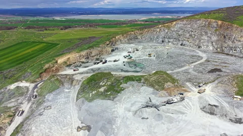 Granite quarry site with machinery working on stone extraction and processing Stock Footage 336597758
