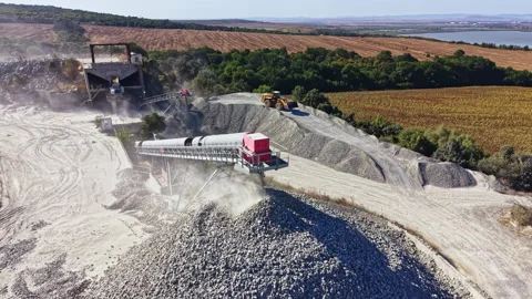 Granite quarry site with machinery working on stone processing in a rural area Stockbeeldmateriaal 344800229