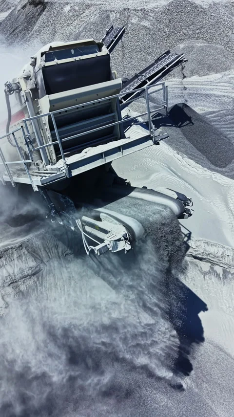 Granite quarry site with mining machinery working on rock extraction and Stock Footage 337894872
