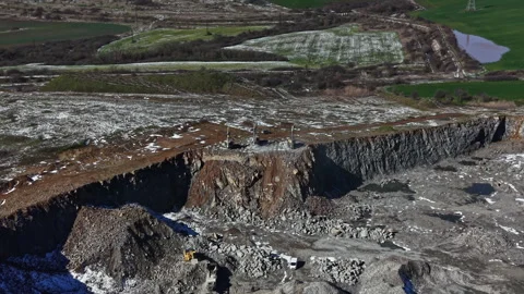 Granite quarry site in operation with mining activities taking place in a large Stock Footage 331938886