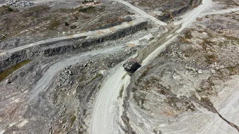 Granite quarry site showing active mining operations and equipment on a sunny Stock Footage 337913479