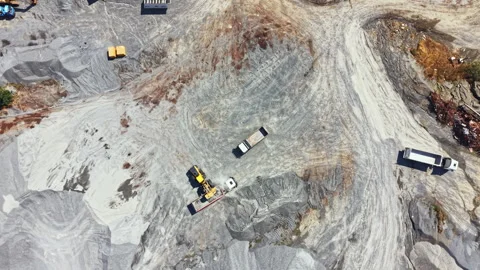 Granite quarry site showing workers and machinery moving materials during Stock Footage 340938574