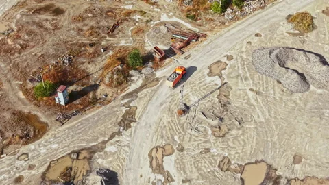 Granite quarry site shows mining activity with heavy machinery operating and Stock Footage 340936217