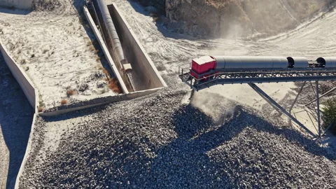 Granite quarry transporting stone using conveyor belts in an active mining site Stock Footage 344775551