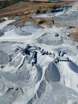 At the granite quarry, workers use heavy machinery to extract and process gra Stock Photos
