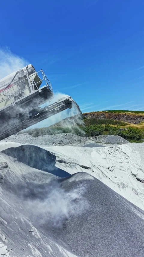 Granite quarrying process shows machine extracting stone materials under a clear Stock Footage 339498181