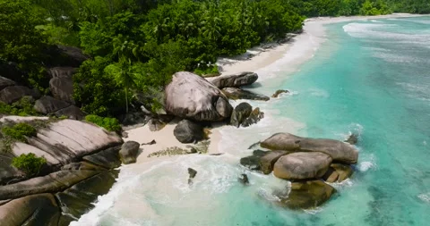 Granite rocks with waves on a tropical beach. Seychelles, Mahe. Stock Footage 345384481