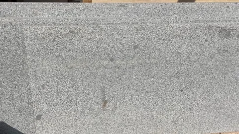 Granite slab surface with speckled texture, perfect for use as a neutral ba.. Stock Footage 328968545