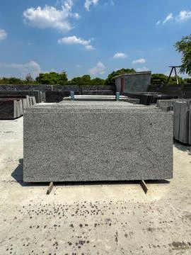 Granite slabs vertically stacked in groups in a granite warehouse Stock Photos
