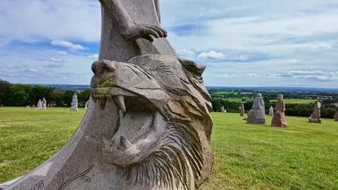 Granite statue of snarling wolf head on hill in Brittany, France Stock Footage 337506471