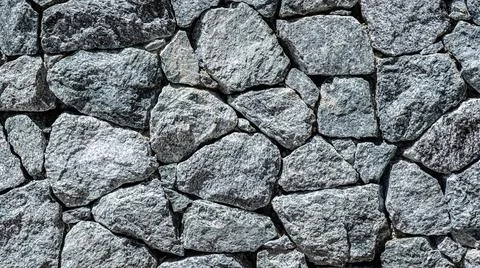 Granite stone wall, pattern of natural gray granite stone wall for background Stock-Fotos