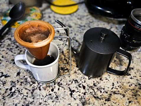Granite table with coffee filter and kettle Stock Photos