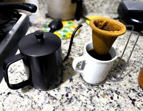 Granite table with coffee filter and kettle Stock Photos