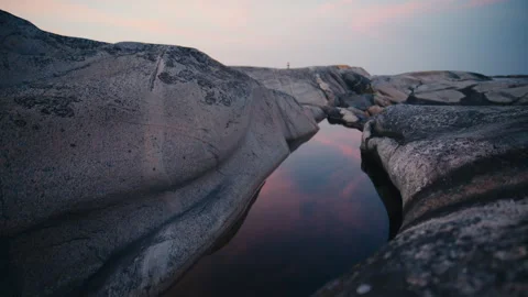 Granite Tide Pool Reflecting a Pastel Evening Sky Stock Footage 341071317