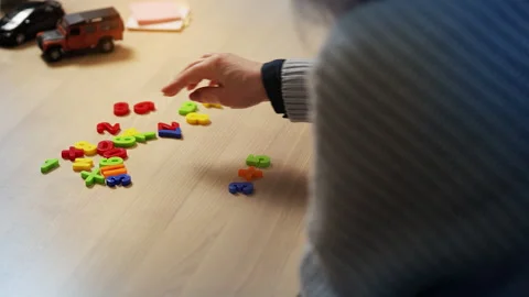 Granny and grandson learning math together using a colorful number toy set Stock Footage 325129159