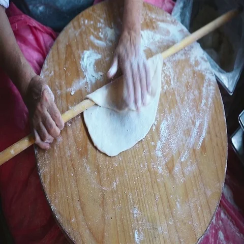 Granny chef cook Turkish pancake Gozleme on the stove Stock Footage 69436206