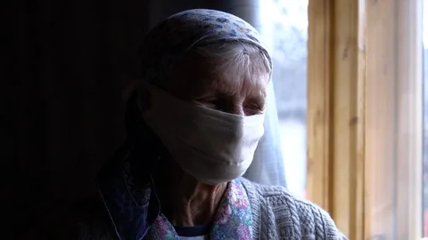 Granny looks at the window Stock Footage 127456348