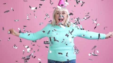 Granny make surprise throw festive serpentine isolated pastel color background Stock Footage 169287798