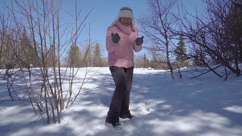 Granny runs through the winter forest and plays a children's game of hide and se Stock Footage 117843260