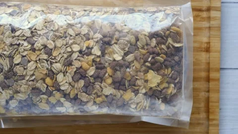 Granola Musli in a plastic packet on table Stock Footage 238705610