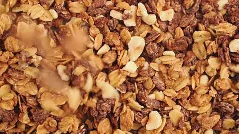 Granola preparation steps with nuts and oats in the kitchen Stock Footage 346517720