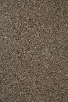 Granular dark brown texture forms detailed close up surface background Stock Photos
