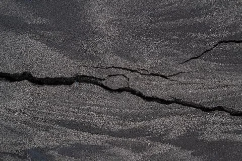 Granular Dark Gray Surface Texture Close-up Showing Prominent Linear Fractu.. Stock Photos