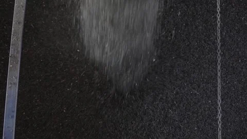 Granular materials such as sand and gravel flowing gracefully over various Stock Footage 310315799