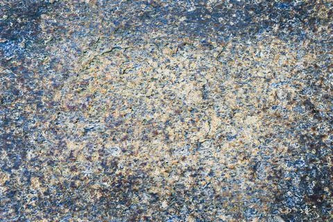 Granular stone texture in bluish and warm tones. Stock Photos