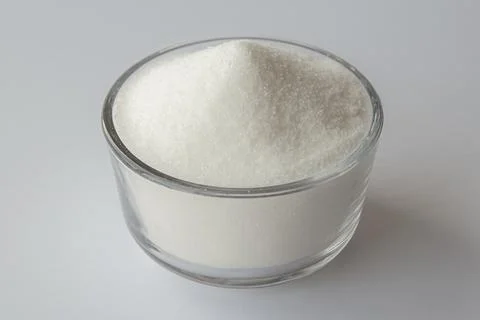 Granulated sugar in a bowl on withe background Stock Photos