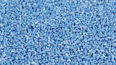 Granule made of polypropylene, Blue Plastic pellets crumbles to the table Stock Footage 148258152