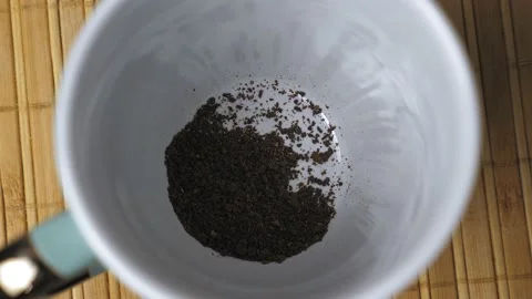 Granules of instant black coffee fall to the bottom of the white mug. Making 스톡 동영상 229587589