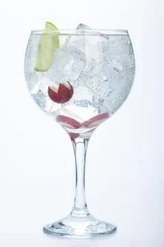 Grape and lime gin tonic isolated over white Stock Photos