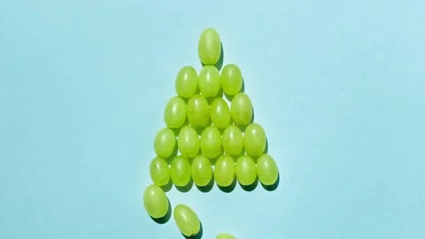 Grape berries shape a Christmas tree loop video. Stop motion 스톡 동영상 143492853
