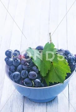Grape in bowl on a table Stock Photos