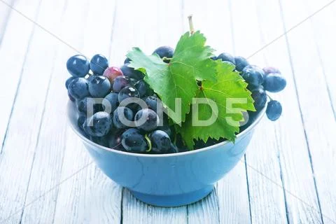 Grape in bowl on a table Stock Photos