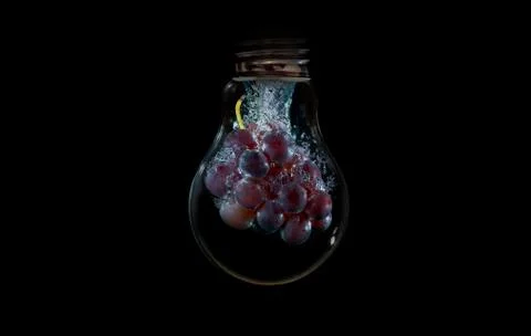 Grape inside a light bulb with water flowing Stock Photos