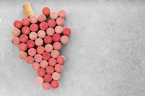Grape made of wine bottle corks on grey table, top view. Space for text 스톡 사진