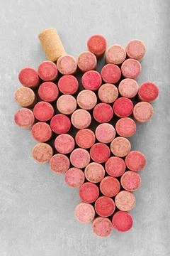 Grape made of wine bottle corks on grey table, top view 스톡 사진