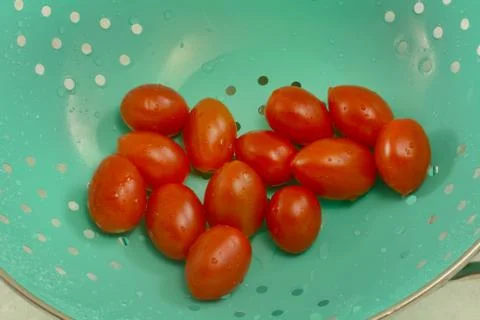 Grape tomatoes in colander Stock Photos