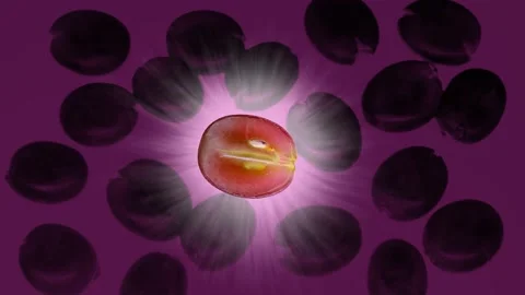 Grape on a yellow background. Rays of light. Rotating slice. Video stock 217005430