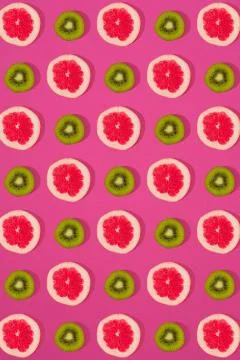 Grapefruit and kiwi pattern on pink background. Minimal flat lay concept. Stock Photos