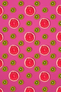 Grapefruit and kiwi pattern on pink background. Minimal flat lay concept. Stock Photos