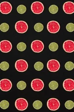 Grapefruit and lemon pattern isolated on black background. Flat lay Stock Photos