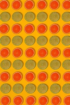 Grapefruit and lime pattern on yellow background. Minimal flat lay concept. Stock Photos