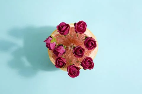 Grapefruit and red roses Stock Photos