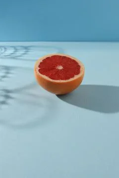 Grapefruit arranged on a bright  blue background. Stock Photos